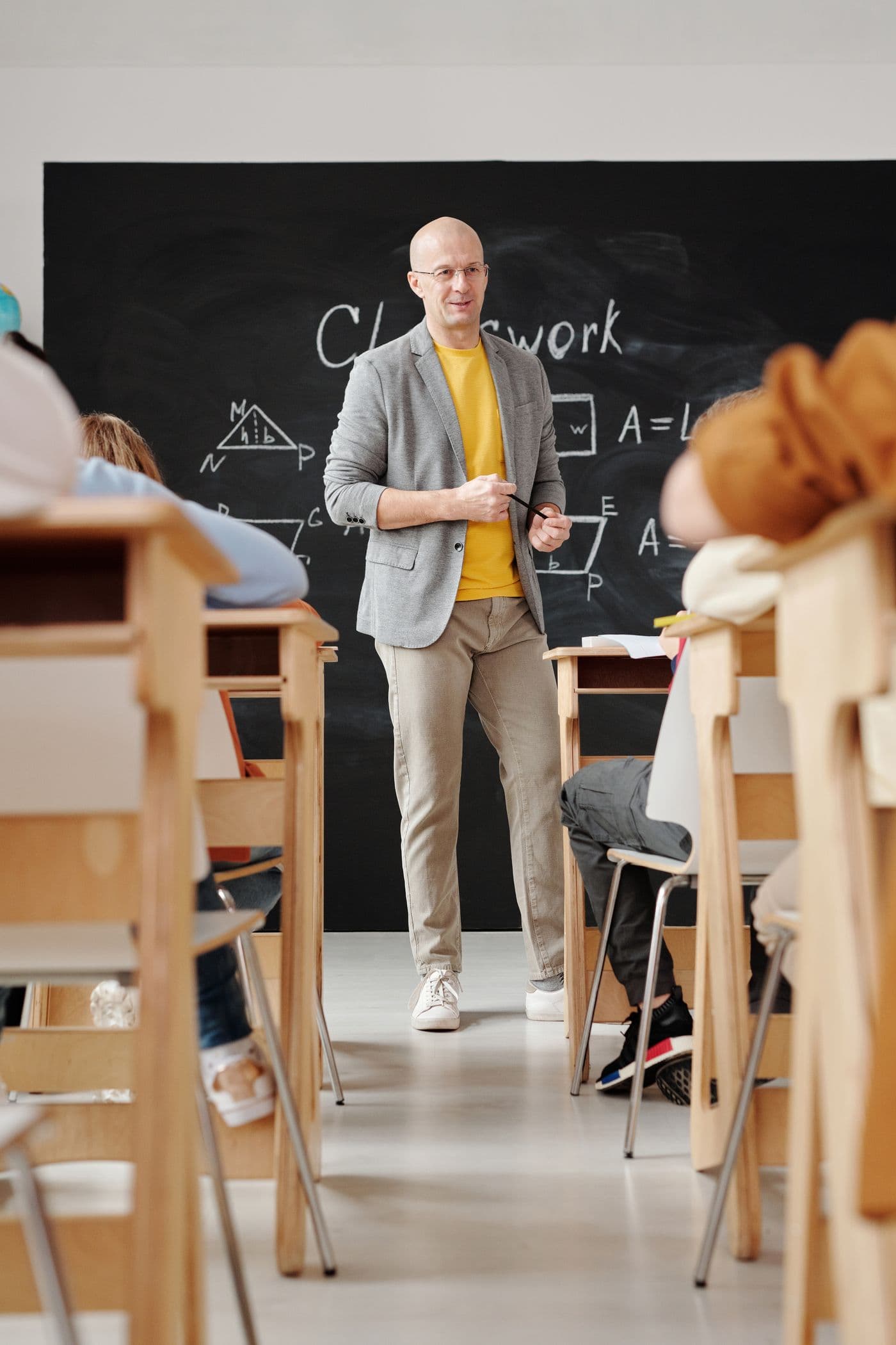 A teacher leading a class at the chalkboard